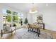 Bright office space features a large window, hardwood floors, and a modern chandelier at 712 Daniels St, Raleigh, NC 27605