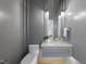 Stylish powder room features gray walls, chandelier lighting, and a marble countertop at 712 Daniels St, Raleigh, NC 27605