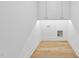 Clean utility room featuring white walls, light hardwood floors, and basic hookups at 712 Daniels St, Raleigh, NC 27605