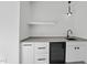 Close-up of wet bar featuring modern cabinets, a beverage cooler, and elegant lighting at 712 Daniels St, Raleigh, NC 27605