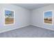 Cozy carpeted bedroom with two windows offering views of the outdoors at 525 Glenkirk Pl, Garner, NC 27529