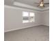 Spacious bedroom with tray ceilings, ceiling fan, and large window providing natural light at 525 Glenkirk Pl, Garner, NC 27529