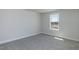 Bright, carpeted bedroom featuring a window allowing natural light to fill the space at 525 Glenkirk Pl, Garner, NC 27529