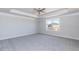 Spacious carpeted bedroom with tray ceiling and large window allowing natural light at 525 Glenkirk Pl, Garner, NC 27529