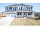 Charming two-story home with a two-car garage and inviting front porch at 525 Glenkirk Pl, Garner, NC 27529