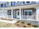 Inviting front porch with white railings and stone accents on a new home at 525 Glenkirk Pl, Garner, NC 27529