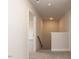 Carpeted hallway with access to the stairs and ample lighting at 525 Glenkirk Pl, Garner, NC 27529