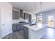 Modern kitchen featuring gray cabinetry, stainless steel appliances, and a center island at 525 Glenkirk Pl, Garner, NC 27529