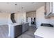 Modern kitchen featuring an island with a sink, stainless steel appliances, and stylish gray cabinets at 525 Glenkirk Pl, Garner, NC 27529