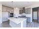 Modern kitchen featuring gray cabinetry, stainless steel appliances, and a center island at 525 Glenkirk Pl, Garner, NC 27529
