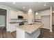 Bright kitchen with white cabinets, granite countertops and stainless steel appliances at 525 Glenkirk Pl, Garner, NC 27529