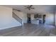 Open-concept living room with staircase, hardwood floors, and views into the kitchen at 525 Glenkirk Pl, Garner, NC 27529