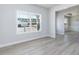 Sunlit living room with large windows overlooking the landscaped yard at 525 Glenkirk Pl, Garner, NC 27529