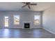 Bright living room featuring a fireplace, hardwood floors, and large windows at 525 Glenkirk Pl, Garner, NC 27529