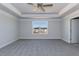Spacious carpeted main bedroom with tray ceiling and large window allowing natural light at 525 Glenkirk Pl, Garner, NC 27529