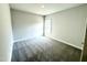 This bedroom features neutral paint, modern carpeting, and natural light from the window at 55 Capeside Ct, Lillington, NC 27546