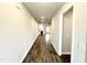 Hallway view with wood-look flooring leading to an open living space with a fireplace and plenty of natural light at 55 Capeside Ct, Lillington, NC 27546