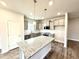 Modern kitchen with granite countertops, stainless steel appliances, a center island, and ample cabinet space at 55 Capeside Ct, Lillington, NC 27546