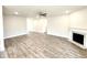 Spacious living room with modern flooring, a sleek fireplace, recessed lighting, and neutral wall paint at 55 Capeside Ct, Lillington, NC 27546