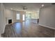 Spacious living room with a fireplace and views of the backyard through sliding glass doors at 55 Capeside Ct, Lillington, NC 27546