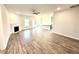 Open living room featuring modern flooring, a fireplace, and seamless flow into the kitchen with a center island at 55 Capeside Ct, Lillington, NC 27546