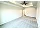 Expansive main bedroom with plush carpeting, a tray ceiling, and a ceiling fan, providing a luxurious retreat at 55 Capeside Ct, Lillington, NC 27546