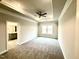 Main bedroom with a tray ceiling, carpet flooring, a ceiling fan, and an ensuite bathroom for added comfort at 55 Capeside Ct, Lillington, NC 27546