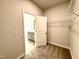 Walk-in closet next to bathroom featuring wire shelving at 55 Capeside Ct, Lillington, NC 27546