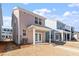 Rear exterior view of newly constructed two-story homes with covered patios and green space at 664 Georgia'S Landing Pkwy # 71, Raleigh, NC 27603