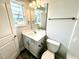 Bathroom with a sink, mirror, toilet, and window offering great natural light at 31 Capeside Ct, Lillington, NC 27546