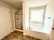 Bathroom featuring tub and glass shower with tile surround, and modern fixtures at 31 Capeside Ct, Lillington, NC 27546