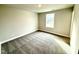 Bedroom featuring gray carpet, light-colored walls, and window at 31 Capeside Ct, Lillington, NC 27546