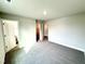 Bedroom featuring gray carpet, light-colored walls, and entrances to a bathroom and closet at 31 Capeside Ct, Lillington, NC 27546