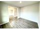 Bedroom featuring gray wood floors and a view into the dining room at 31 Capeside Ct, Lillington, NC 27546