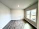 Bedroom featuring gray wood floors and a large window with natural light at 31 Capeside Ct, Lillington, NC 27546