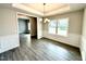 Dining room featuring gray wood floors, modern chandelier, and views into the next room at 31 Capeside Ct, Lillington, NC 27546