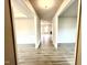 Hallway featuring gray wood floors and a view into the living room with a fireplace at 31 Capeside Ct, Lillington, NC 27546