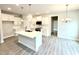 Bright, open kitchen with a large island, white cabinets, and modern appliances offers a stylish cooking space at 31 Capeside Ct, Lillington, NC 27546
