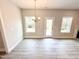 Open living room features bright windows and a modern light fixture at 31 Capeside Ct, Lillington, NC 27546
