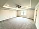 Spacious primary bedroom with tray ceiling and large window at 31 Capeside Ct, Lillington, NC 27546