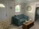 Living room with teal couch and coffee table at 709 W Horne St, Clayton, NC 27520