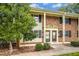 Well-maintained townhome featuring a brick facade, manicured bushes, and a cozy entrance at 1002 Willow Dr # Apt 7, Chapel Hill, NC 27514