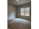 Cozy bedroom with neutral carpet and a large window at 105 Watermelon Dr, Franklinton, NC 27525