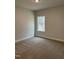 A clean, empty bedroom has neutral colored walls, and a large picture window at 105 Watermelon Dr, Franklinton, NC 27525