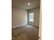 A neutral, clean, empty bedroom features a large window at 105 Watermelon Dr, Franklinton, NC 27525