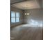 Bright dining room featuring a modern chandelier, wainscoting, and hardwood floors at 105 Watermelon Dr, Franklinton, NC 27525