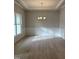 Bright dining room featuring a modern chandelier, wainscoting, and hardwood floors at 105 Watermelon Dr, Franklinton, NC 27525