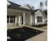 Beautiful front exterior with stone accents, a covered porch, and black mulch landscaping at 105 Watermelon Dr, Franklinton, NC 27525