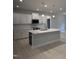 Well-lit kitchen with quartz countertops, stainless steel appliances, and a kitchen island at 105 Watermelon Dr, Franklinton, NC 27525