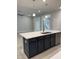 Kitchen island with stainless steel sink, dark blue cabinets, and white countertops at 105 Watermelon Dr, Franklinton, NC 27525